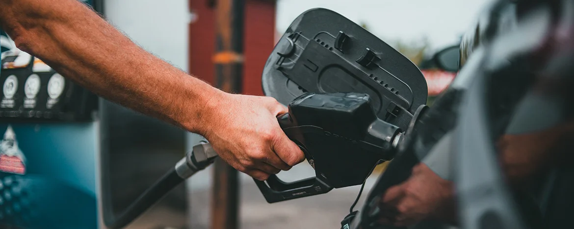 person filling up car with fuel